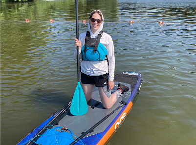 photo of guide kneeling on paddleboard