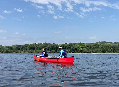 photo of two people in canoe on river